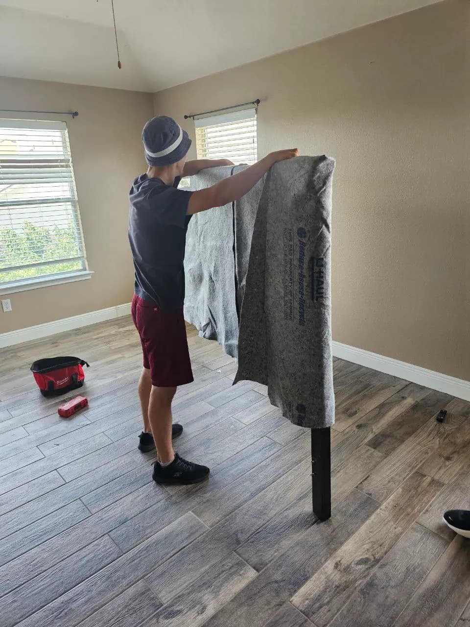Mover holding a moving blanket ready for wrapping