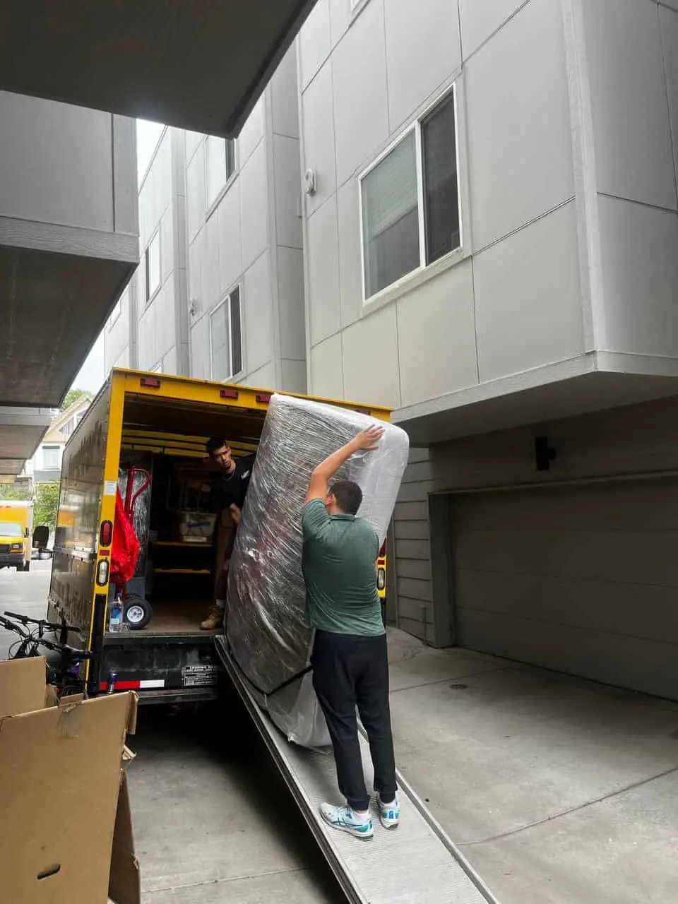 Mover lifting a wrapped item into the truck