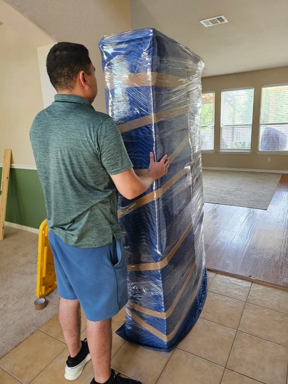 Mover securing padding around a wrapped item
